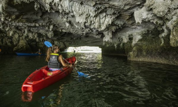 Guests kayak in Halong Bay.