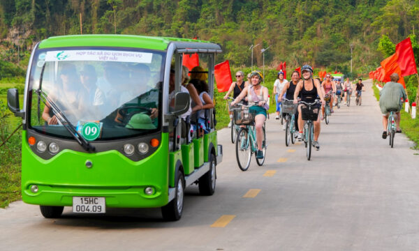 Electric carts and bikes on the road of Viet Hai Village.