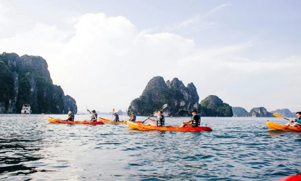 People kayak on Thien Canh Son sea.