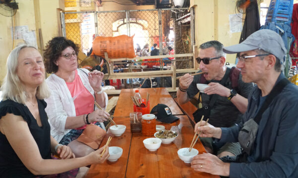 Foreign guests trying Sapa specialties in Bac Ha Market.