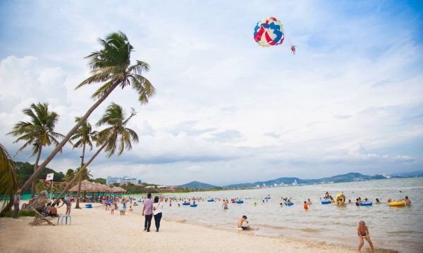 Tuan Chau beach with many people swimming.
