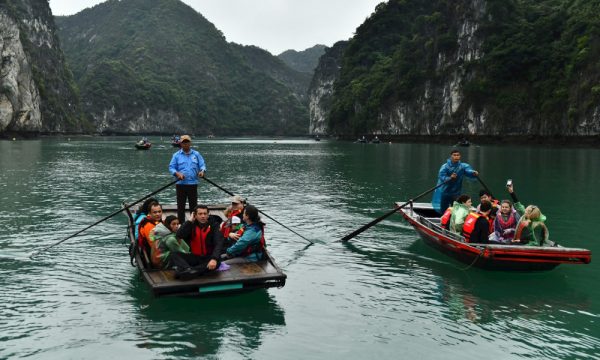 Two bamboo boats sailing in Lan Ha Bay.