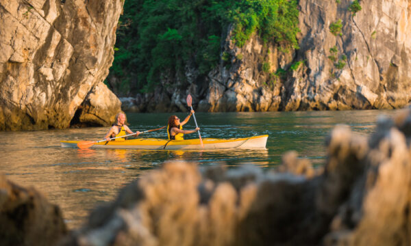 Dragon Legend guests kayaking in Bai Tu Long Bay.