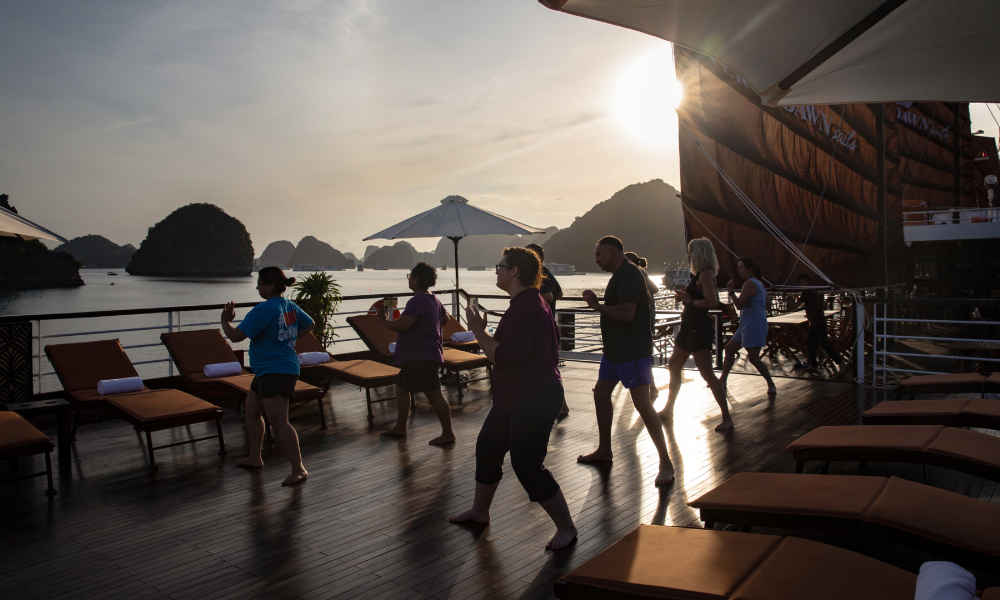 Guests doing tai chi on V'Spirit Cruise sundeck.